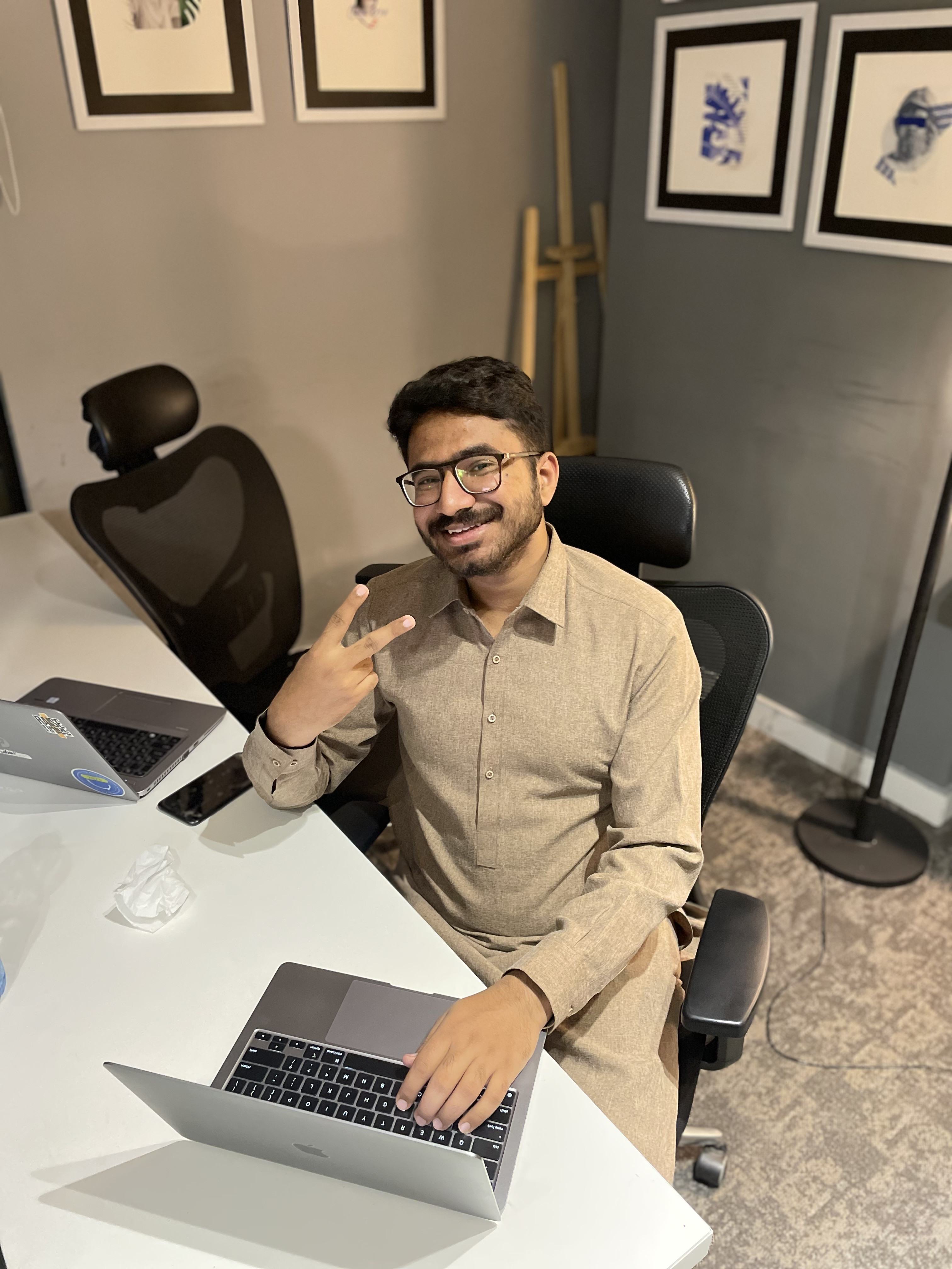 Hamza Shabbir (UXHAMZA), product designer working at his desk in Figma